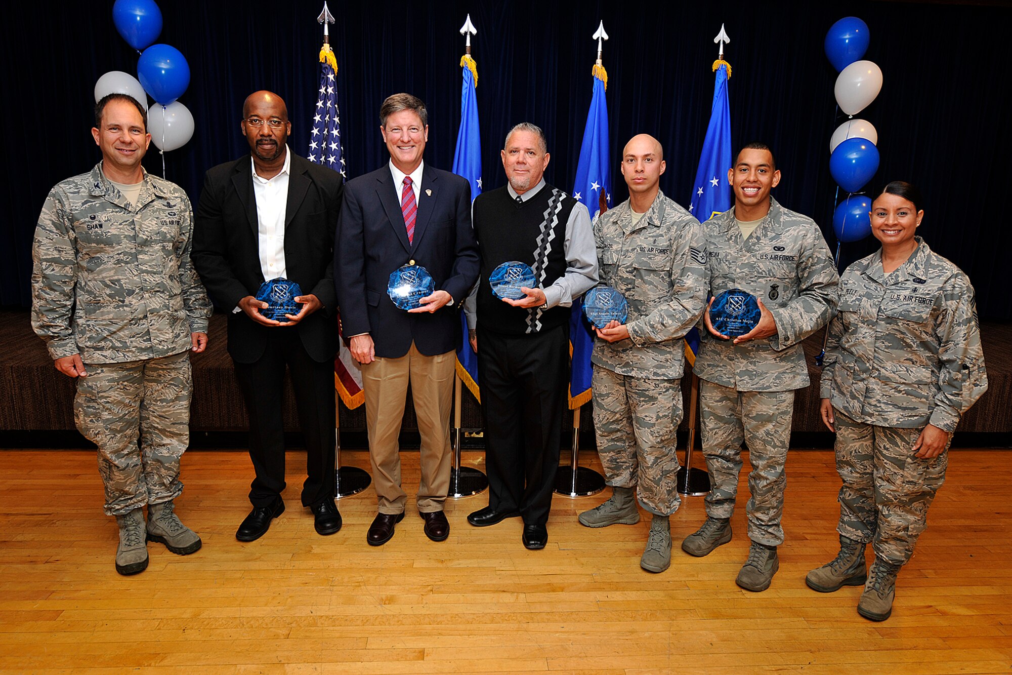 PETERSON AIR FORCE BASE, Colo. — The 21st Space Wing held its quarterly awards breakfast for the second quarter July 29 at The Club. Col. John Shaw (left), 21st SW commander, and Chief Master Sgt. Idalia Peele (right), 21st SW command chief, presented the awards, including: Airman of the quarter -- Airman 1st Class Christian Mejia, 721st Security Forces Squadron; NCO of the quarter -- Staff Sgt. Angelo Tafoya, 21st Medical Group; Senior NCO -- Master Sgt. Karen Cullen, 821st Air Base Group; Company grade officer -- 2nd Lt. Benjamin Brinich, 21st Operations Group; Civilian category I -- Daniel Bermudez, 21st Mission Support Group; Civilian category II -- Claudia Thew, 21st Wing Staff Agencies; Civilian category III -- Michael Cramer, 21st WSA; and Civilian supervisory category -- Courtney Davis, 21st OG. The local winners go on to represent the wing at the Team Pete quarterly awards competition. (U.S. Air Force photo/Dennis Howk)