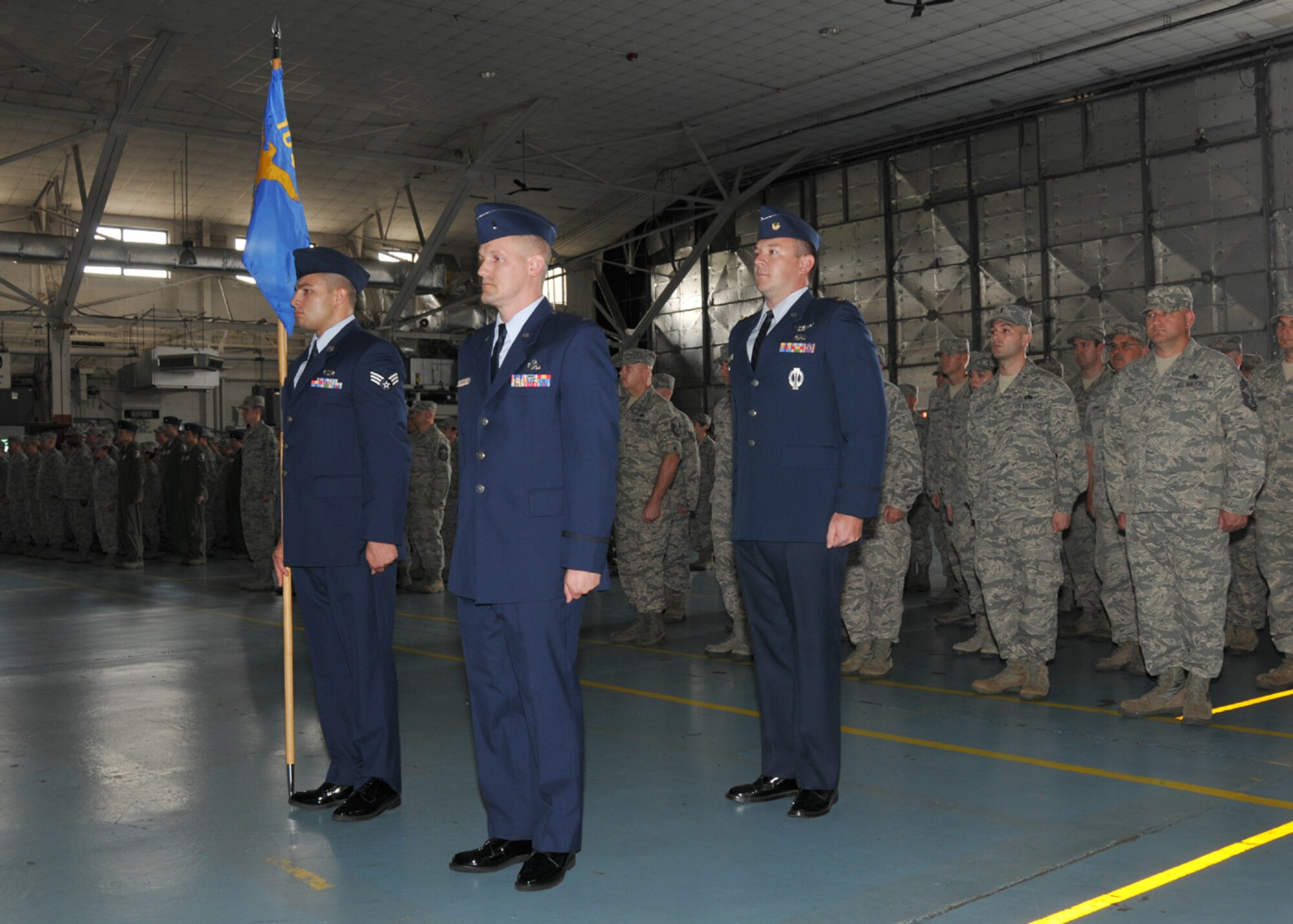 1st Lt. Jason Hickox stands by ready to assume command from Maj. Jason Roberts. The Maintenance Operations Flight change of command ceremony was held Aug. 2, 2014, in the main hangar at Barnes Air National Guard Base, Westfield, Mass., where 1st Lt. Jason Hickox assumed command from Maj. Jason Roberts. (U.S. Air National Guard photo by Master Sgt. Mark Fortin/Released)