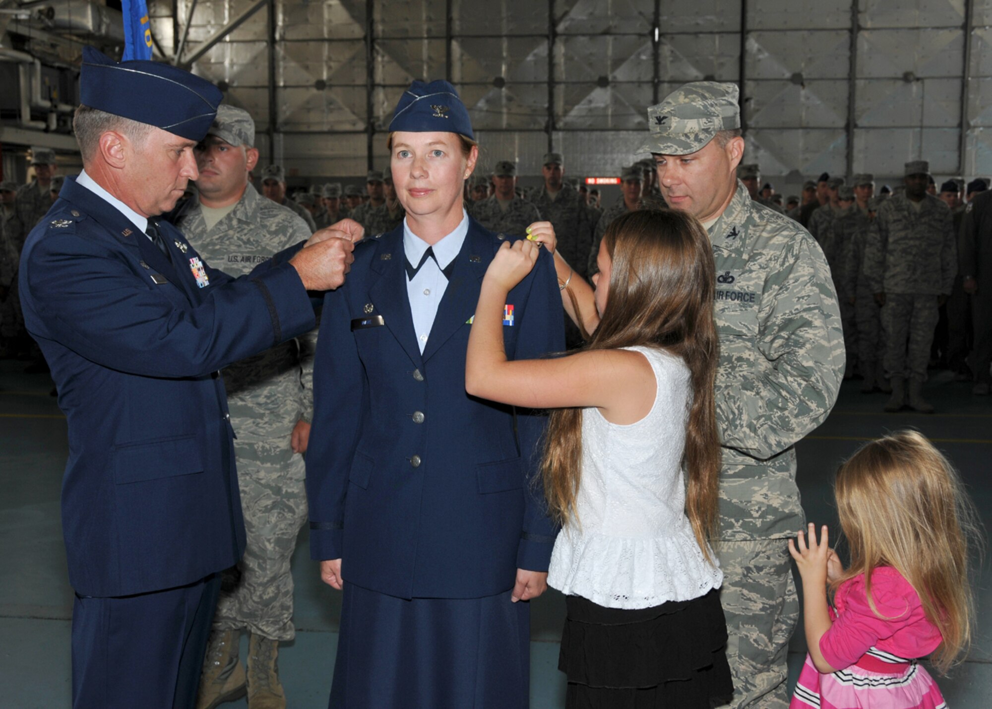 Lt. Col. Ann Ware was promoted to the rank of colonel in a ceremony held 
Aug. 2, 2014, in the main hangar at Barnes Air National Guard Base, Westfield, Mass.  Col. 
James Keefe, 104th Fighter Wing Commander, her husband Col. Robert Ware, and 
her two daughters Abigale and Rachel pinned on her new rank. (U.S. Air National Guard photo by Master Sgt. Mark Fortin/Released)