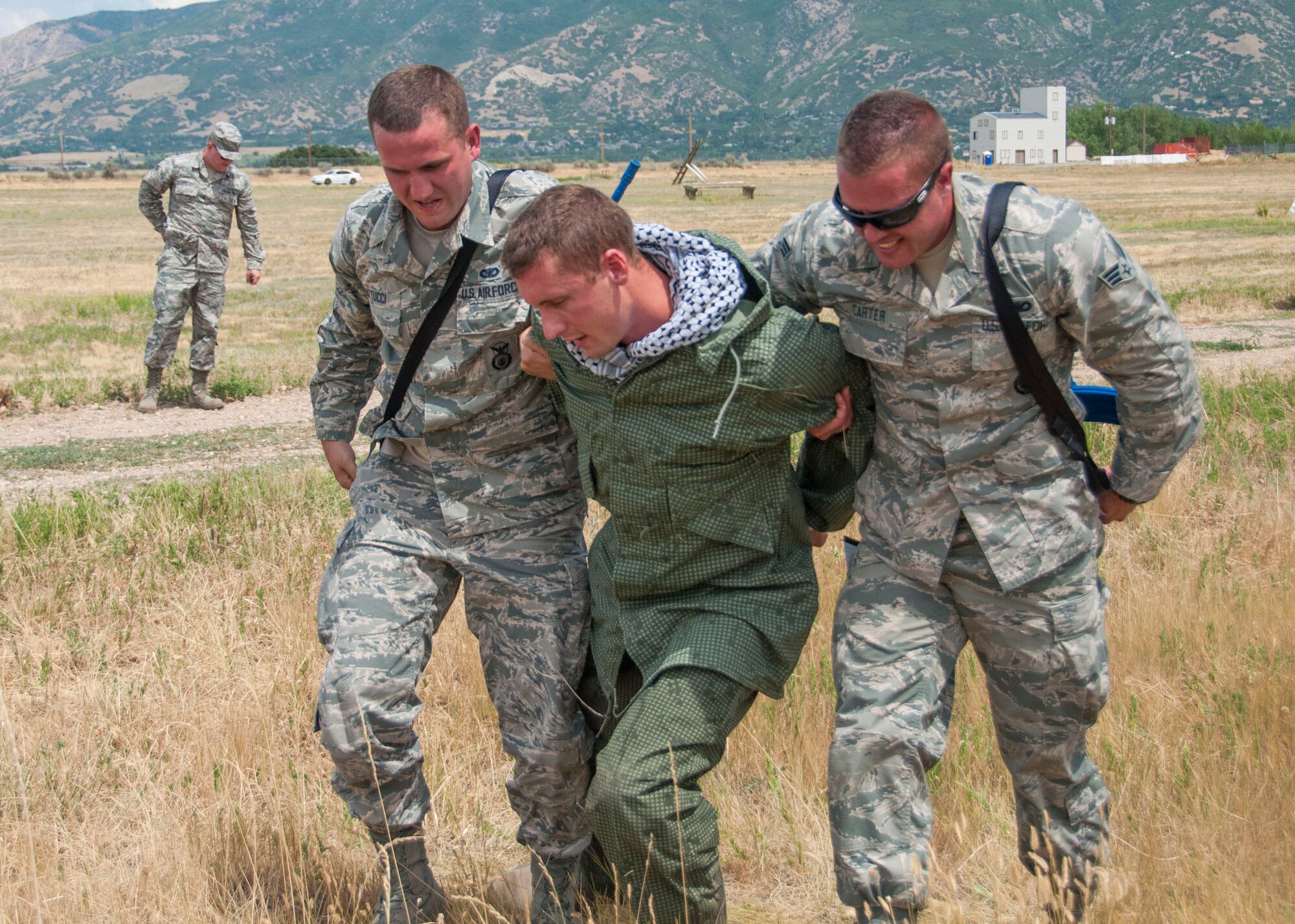 Airman Basic Matthew Mattucci and Senior Airman Shawn Carter, 419th Security Forces Squadron, escort Tech. Sgt. David Hasseler, playing an enemy prisoner, to the entry control point. (U.S. Air Force photo/Staff Sgt. Crystal Charriere)