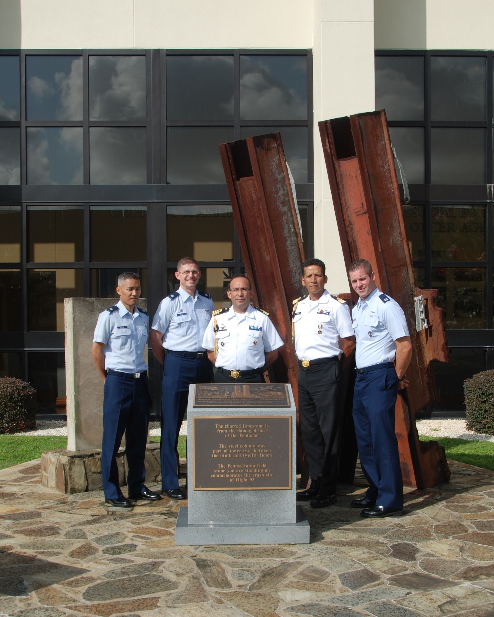 "Rescue professionals from the Mexico Rescue Coordination Center visited the U.S. Air Force Rescue Coordination Center here for a Search and Rescue Subject Matter Exchange July 22-25. U.S. Air Force members Maj. Joel Bolina, North American Aerospace Defense Command-U.S. Northern Command Special Staff; Lt. Col. Ian Kemp, AFRCC commander, and Capt. Matthew Shemo, an AFRCC Search and Rescue duty officer, joined their MRCC counterparts for a photo opportunity at the 9-11 Memorial at the 601st Air and Space Operations Center here. During the exchange, the rescuemen collaborated in building a cross-border civil-rescue exercise that will demonstrate the full capabilities of both nations in rescuing pilot and passengers from a downed private aircraft. (Photo by Capt. Jared Scott)
