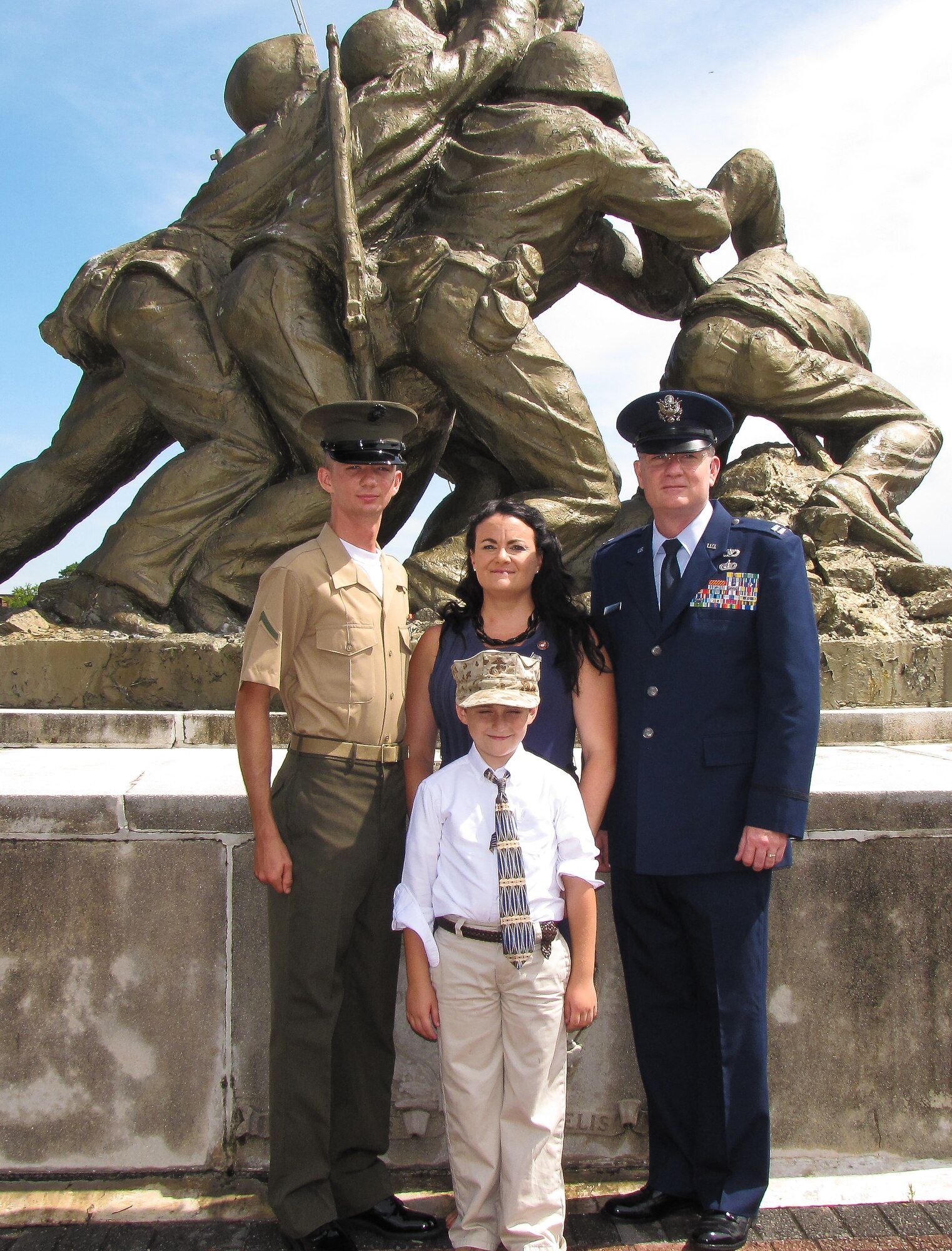 U.S. Air Force Capt. Robert Brumfield, an operations officer with the 116th Security Forces Squadron, Georgia Air National Guard, poses with his family including; son U.S. Marine Pfc. Blake Brumfield, wife Theresa and son Zane in front of the Iwo Jima statue at Marine Corp Recruit Depot, Parris Island, S.C., June 05, 2014. Brumfield and his family posed for the photo after Blake’s graduation from boot camp. (Contributed photo/Released)