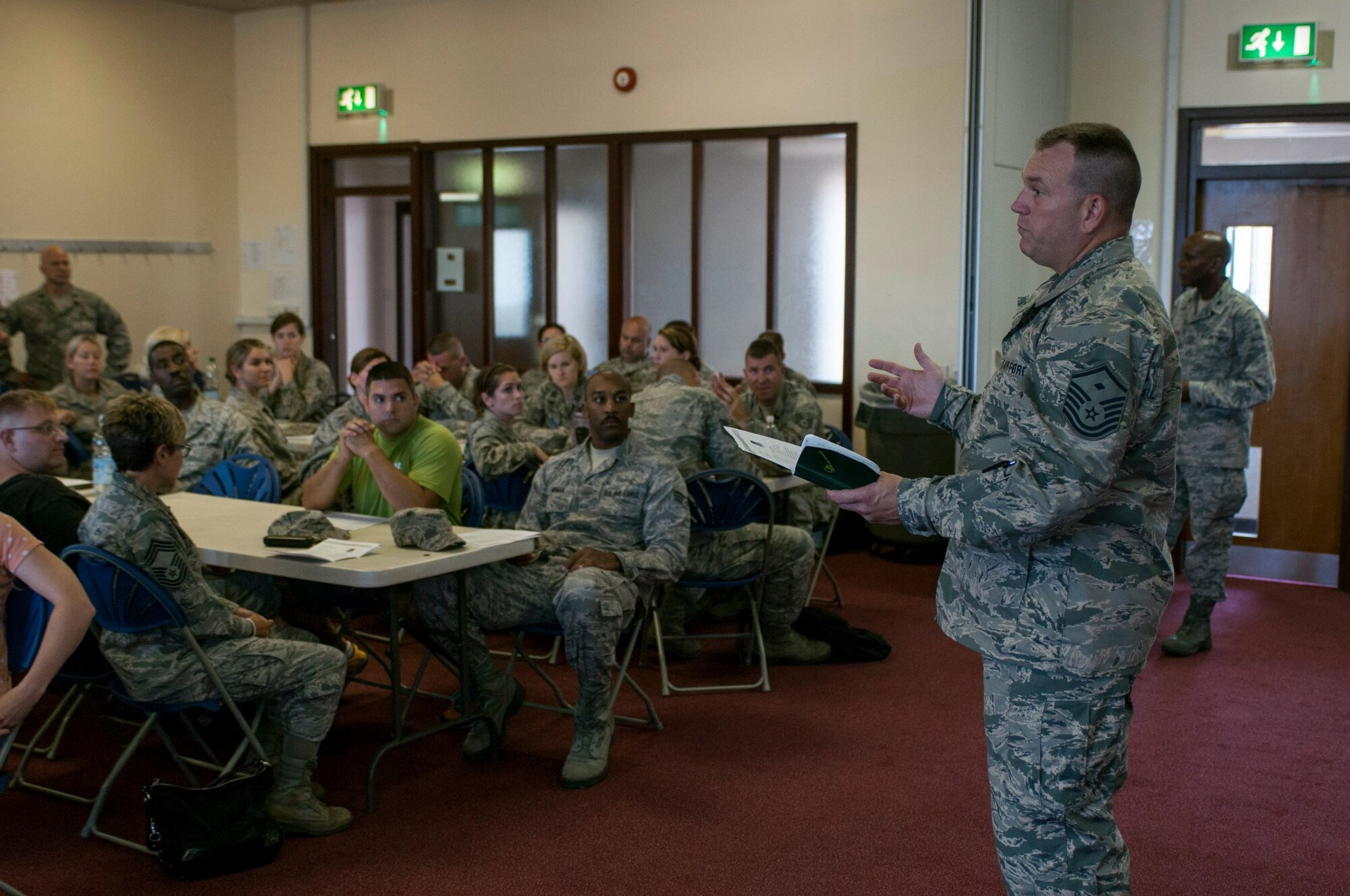 Master Sgt. Jeffrey Jones gives a First Sgt. briefing to members of the Ohio Air National Guard at RAF Lakenheath on July 29, 2014. The Ohio Air National Guard has members from the 121st Air Refueling Wing, 179th Airlift Wing, and 180th Fighter Wing training with active duty counterparts from their specific career fields working with both RAF Mildenhall and RAF Lakenheath. (U.S. Air National Guard photo by Tech. Sgt. Zachary Wintgens/Released) 