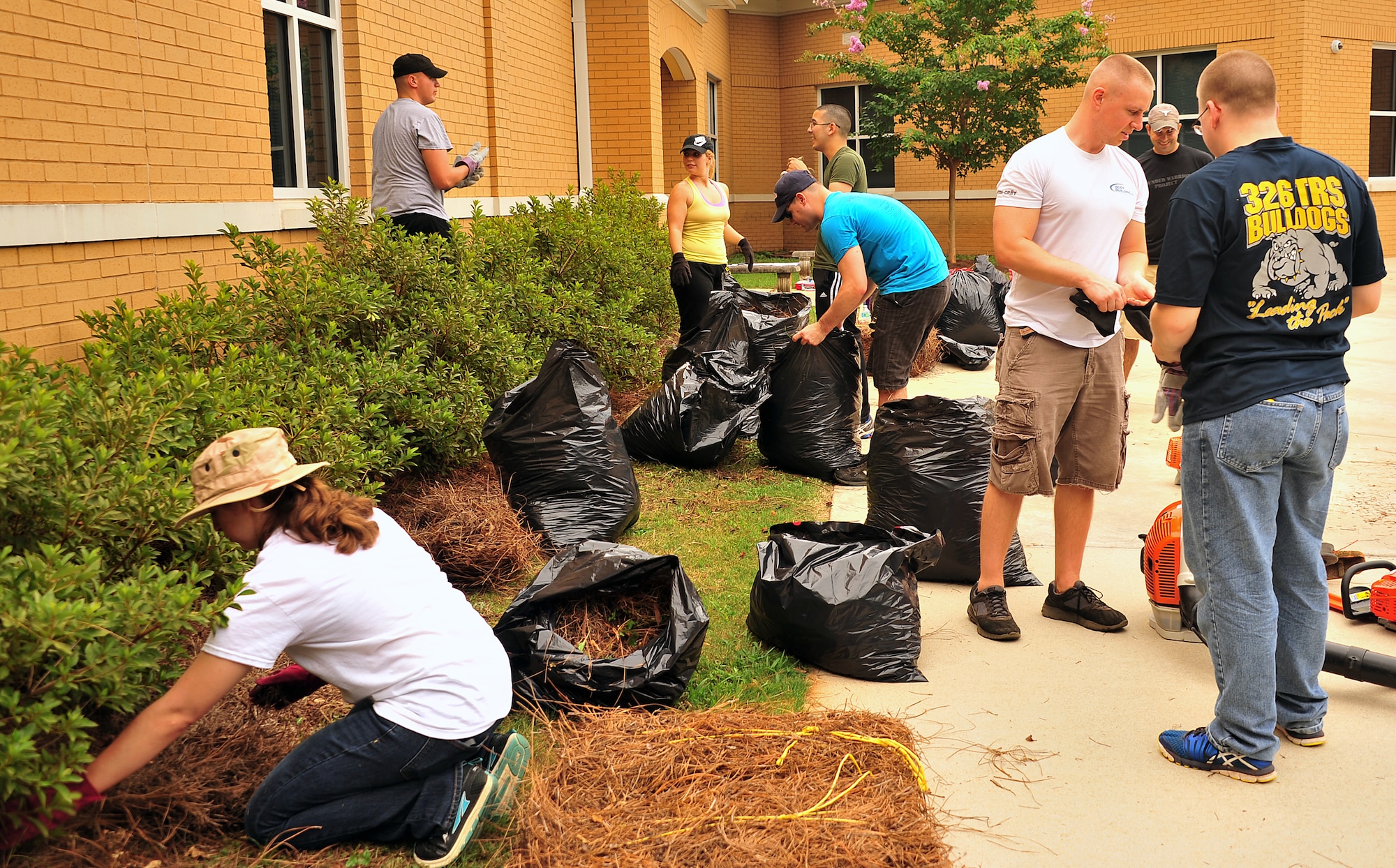 Members of the Air Force Life Cycle Management Center at Maxwell’s Gunter annex volunteered to clean-up the grounds at Dalraida Elementary School in Montgomery, Ala., Friday, Aug. 1, 2014.  The volunteer effort, organized by the AFLCMC Top 3, dubbed a “beautification project” included 25 military personnel doing general grounds maintenance. (U.S. Air Force photo by/Staff Sgt. Erica Picariello)