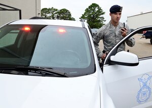 U.S. Air Force Staff Sgt. Walter Stiles, 633rd Security Forces Squadron response force leader, receives a dispatch from the Base Defense Operations Center at Langley Air Force Base, Va., Aug. 1, 2014. Security forces Airmen guard aircraft and specialized weapons and provide police functions, including traffic safety and detaining suspects. (U.S. Air Force photo by Senior Airman Connor Estes/Released)