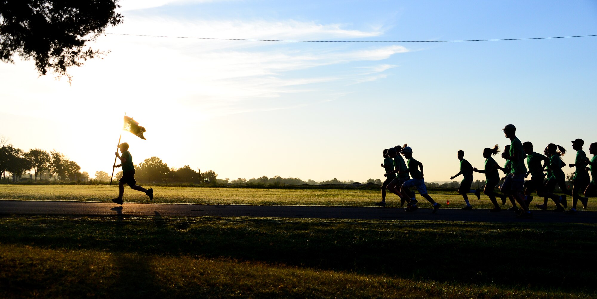 Kids Kamp participants, children of Oklahoma National Guard members, exercise during morning physical training at Camp Gruber in Braggs, Okla., July 24, 2014. Each morning campers endure various military fitness activities led by volunteers. (U.S. Air Force photo by Airman 1st Class Tyler Woodward/Released)