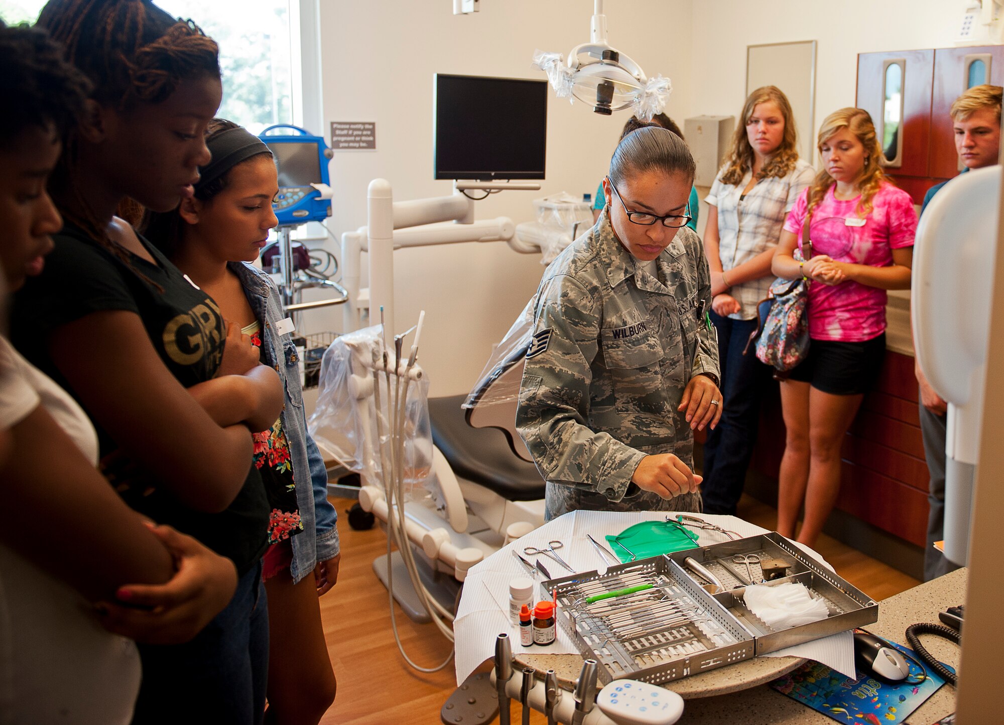 Staff Sgt. Mariangeli Wilburn, of the 96th Dental Squadron, describes the various tools and instruments used in the Dental Clinic during the Kid's Career Day at Eglin Hospital July 30. More than 20 children took part in the day-long event to get a hands-on perspective of the various career opportunities available in the medical field as well as the Air Force Medical Service. (U.S. Air Force photo/Sara Vidoni)