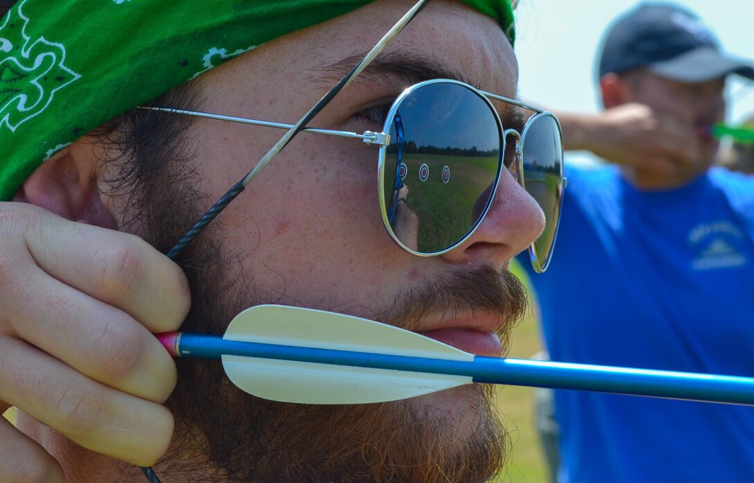 Brett Keenan, a Kids Kamp youth volunteer leader from Choctaw, Okla., sets his sights on a target during archery practice at Camp Gruber in Braggs, Okla., July 21, 2014. Keenan has been an active member of Kids Kamp for nine years. The weeklong camp is designed to teach Army and Air Force core values to children of Oklahoma National Guard members. (U.S. Air Force photo by Airman 1st Class Kasey Phipps/Released)