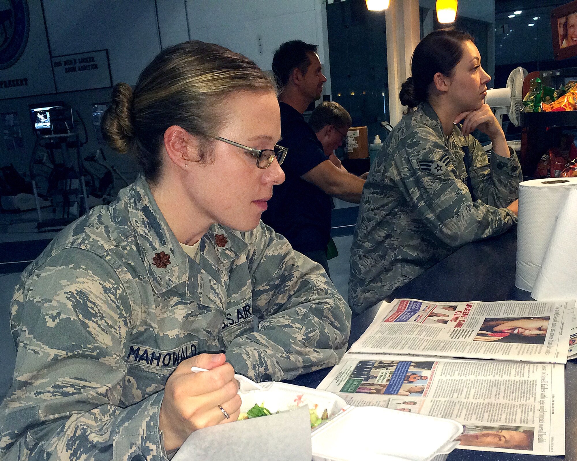 U.S. Air Force Maj. Heather Mahowald, U.S. Strategic Command individual mobilization augmentee, reads the newspaper while enjoying her lunch at Smoothalicious June 6 inside of the Offutt Field House. Since its opening, Smoothalicious has seen a business increase of 204 percent over the previous owner.  (U.S. Air Force photo by D.P. Heard/Released)