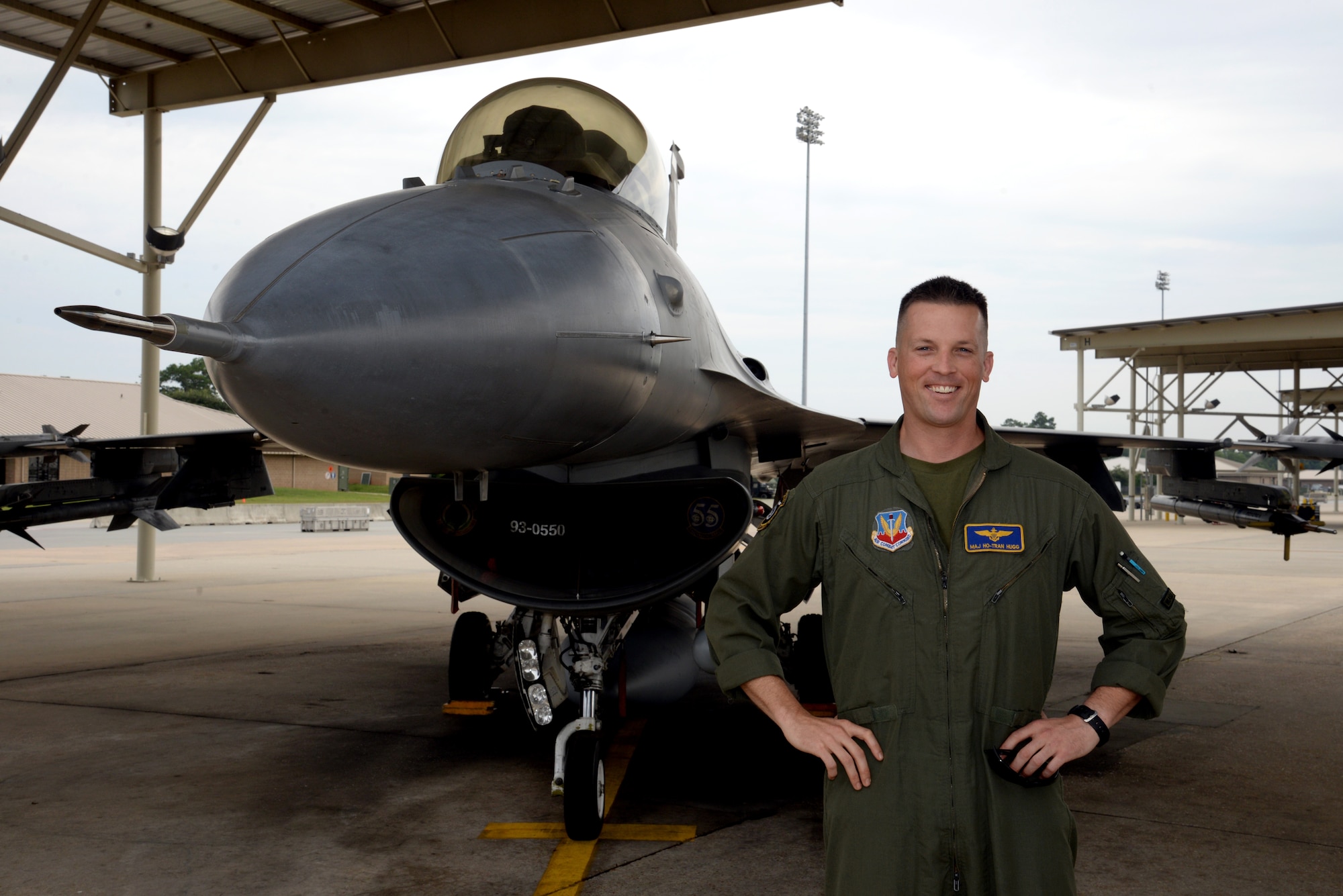 U.S. Marine Corps Maj. Eric Hugg, 55th Fighter Squadron chief of training, stands next to an F-16CJ Fighting Falcon at Shaw Air Force Base, S.C., July 31, 2014. Hugg is a trained A/V-8B II Harrier pilot in the Marine Corps assigned to the 55th FS as an F-16 pilot, part of a USMC and USAF exchange program, that allows Marine aviators the first-hand experience to work with Airmen and how the Air Force accomplishes its mission. (U.S. Air Force photo by Airman 1st Class Jonathan Bass/Released)
