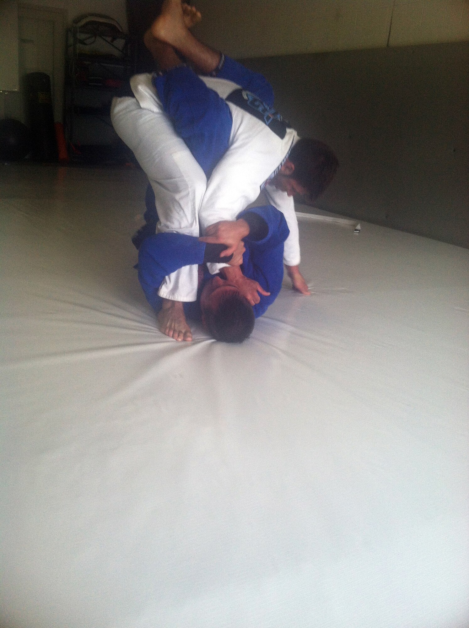 WRIGHT-PATTERSON AIR FORCE BASE, Ohio – (on the ground) Maj. Eric Palichat, 89th Airlift Squadron C-17 pilot, spars with a professional mixed martial arts fighter Rob Hanna, during a Brazilian jiu-jitsu class July 17, 2014. Palichat has been studying and training Brazilian jiu-jitsu for the last six years. (Courtesy photo)