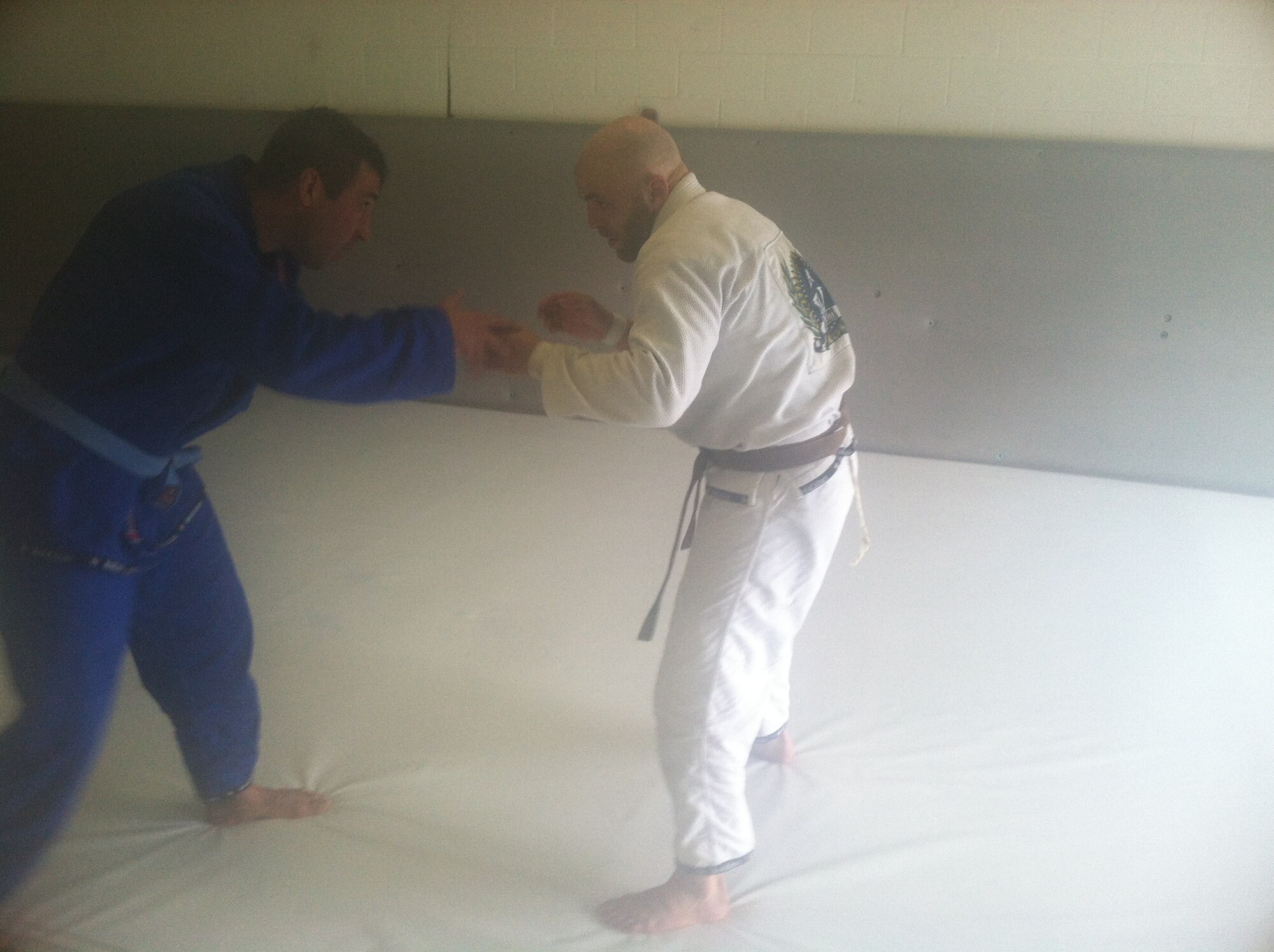 WRIGHT-PATTERSON AIR FORCE BASE, Ohio – (left) Maj. Eric Palichat, 89th Airlift Squadron C-17 pilot, spars with a professional mixed martial arts fighter Justin Edwards, during a Brazilian jiu-jitsu class July 17, 2014. Palichat has been studying and training Brazilian jiu-jitsu for the last six years. (Courtesy photo)