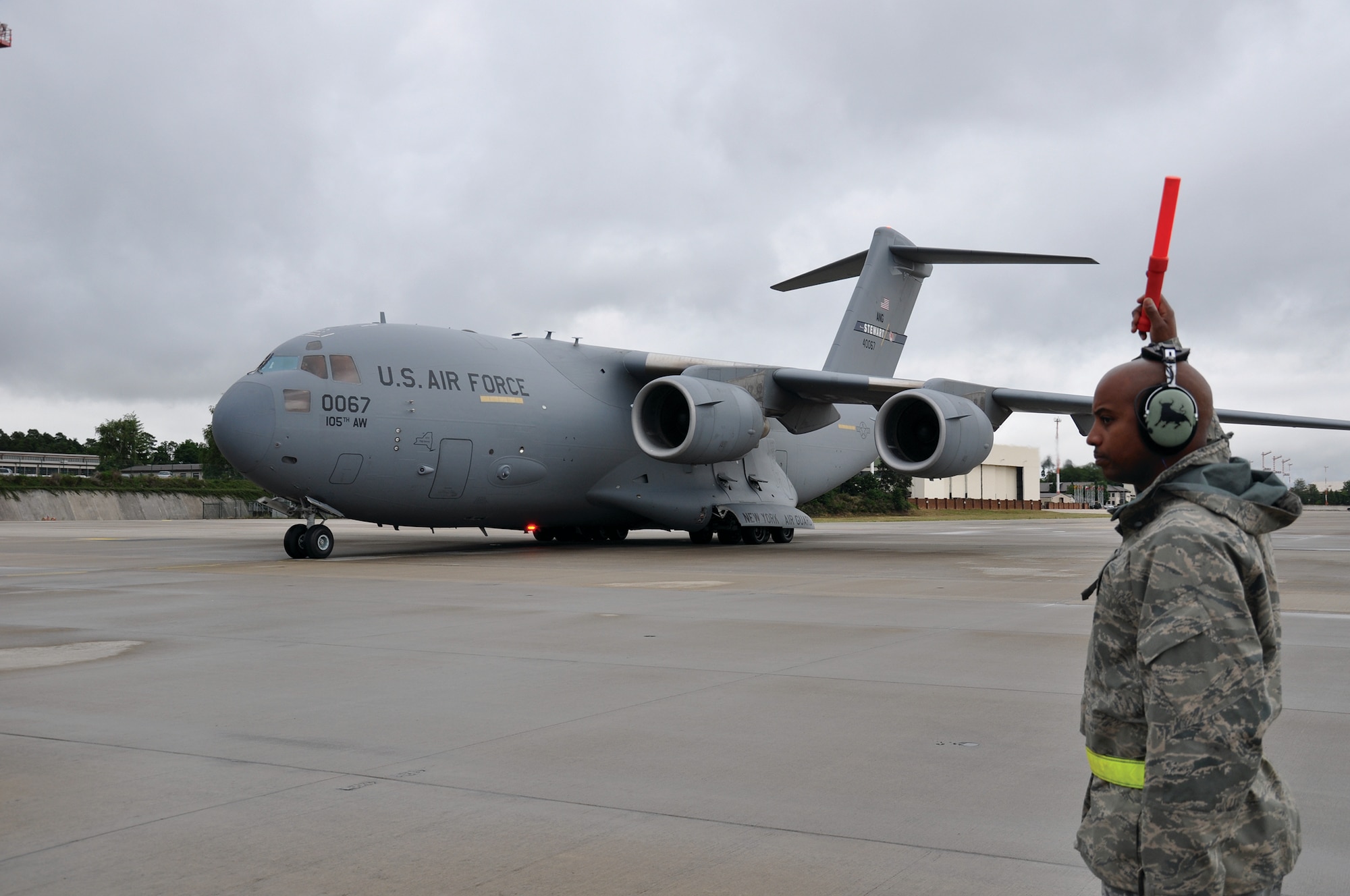 RAMSTEIN AIR BASE, Germany - Tech. Sgt. Keric Johnson, 445th Aircraft Maintenance Squadron C-17 Globemaster III crew chief, marshals in a C-17 at Ramstein Air Base, Germany, July 10, 2014. The 445 AMXS sent 20 maintainers to Germany to serve annual tour time July 7-21. (U.S. Air Force photo/Capt. Elizabeth Caraway)