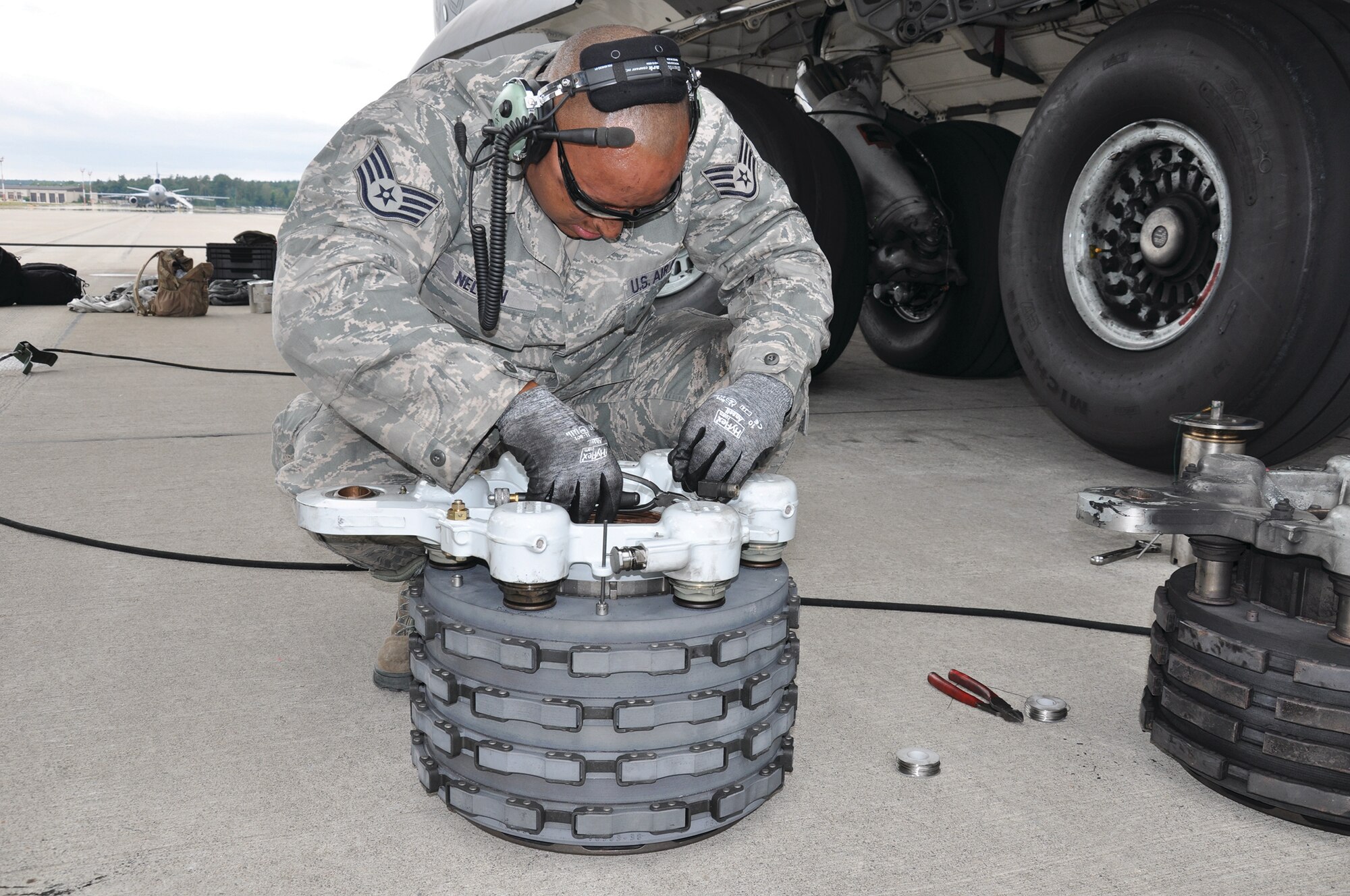 RAMSTEIN AIR BASE, Germany - Staff Sgt. Jacob Nelson, 445 Aircraft Maintenance Squadron crew chief, works on a C-17 Globemaster III brake safety wire during a brake replacement July 10, 2014. The worn brake can be seen at right. The 445 AMXS sent 20 maintainers to Germany to serve annual tour time July 7-21. (U.S. Air Force photo/Capt. Elizabeth Caraway)