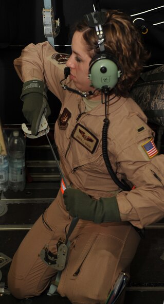 An Airman from the 86th Aeromedical Evacuation Squadron converts a C-130J Super Hercules mid-air using a specialized configuration for the first time on a real-world mission, July 26, 2014. There were two surgery tables with patient-monitoring equipment along with several other litters on the C-130. (U.S. Air Force photo/Senior Airman Hailey Haux)