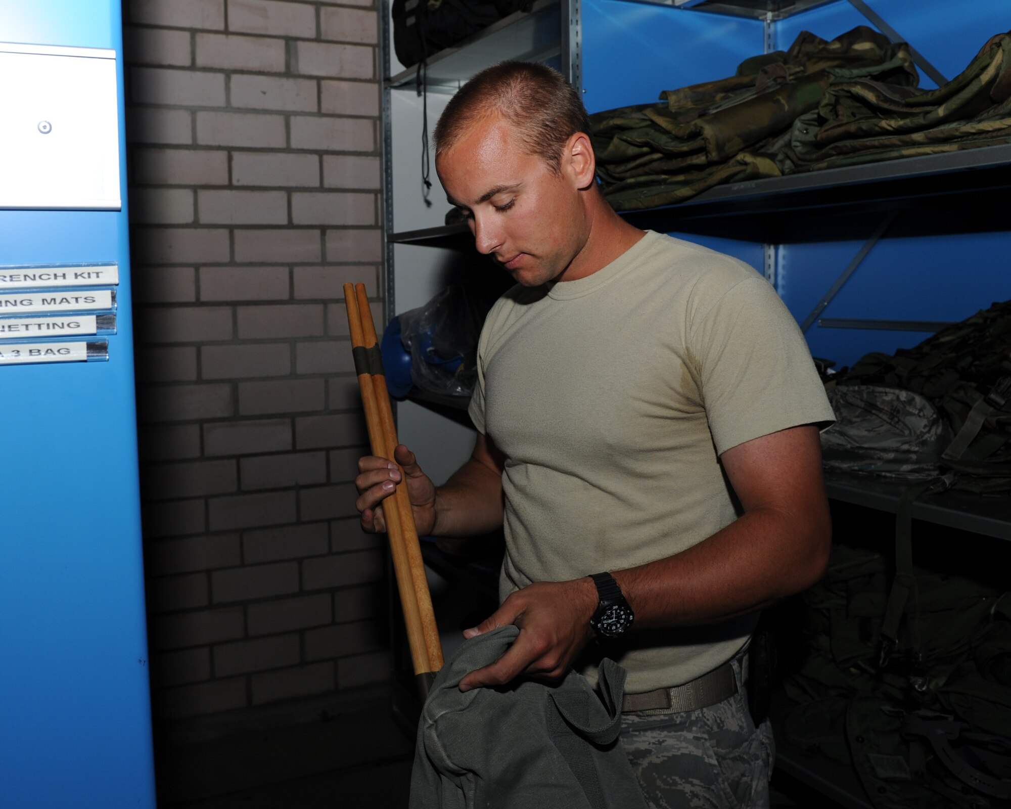 U.S. Air Force Senior Airman Ryan Maxwell, a 606th Air Control Squadron materiel management specialist from Yorktown, Va., creates an initial issue bag July 30, 2014, at his squadron at Spangdahlem Air Base, Germany. Airmen use the bags during exercises and other training functions to maintain proficiency and readiness for when they are called upon by combatant commanders to deploy. (U.S. Air Force photo by Airman 1st Class Dylan Nuckolls/Released)