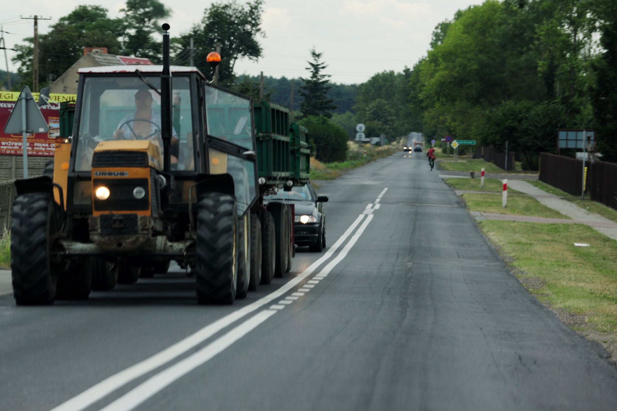 A tractor hauls local farming goods and supplies along the road to Powidz Air Base, Poland, Aug. 1, 2014. Nearly 75 years ago, these roads were packed with troops from Nazi Germany, as they invaded the country. (U.S. Air Force photo by Staff Sgt. Jarad A. Denton/Released)