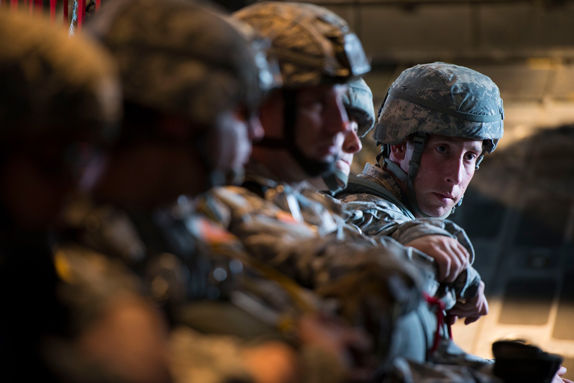 An Army Jump Master from the 725th Brigade Support Battalion receives instructions from 36th Airlift Squadron loadmasters prior to parachuting from a C-130 Hercules during an off-site training sortie Aug. 1, 2014 at Joint Base Elmendorf-Richardson, Alaska. This was the first of several jumps the two units successfully completed during the joint training. (U.S. Air Force photo by Staff Sgt. Chad C. Strohmeyer/Released)