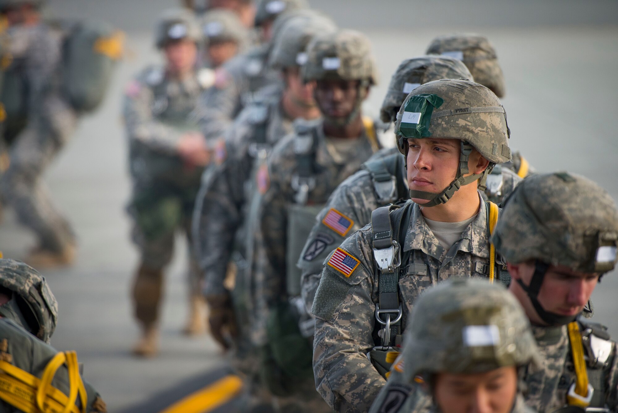 Army Paratroopers from the 725th Brigade Support Battalion prepare to board a C-130 Hercules from the 36th Airlift Squadron prior to a training sortie Aug. 1, 2014 at Joint Base Elmendorf-Richardson, Alaska. The two units worked together to drop more than 90 paratroopers in two hours. (U.S. Air Force photo by Staff Sgt. Chad C. Strohmeyer/Released)