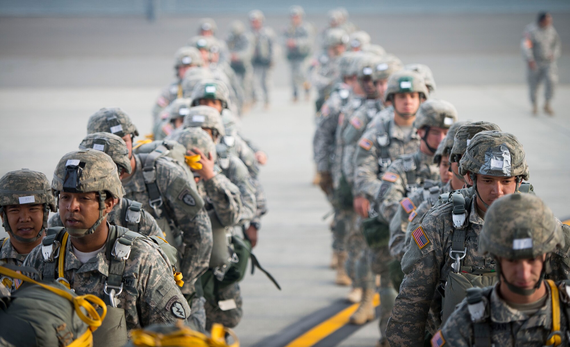 Army Paratroopers from the 725th Brigade Support Battalion prepare to board a C-130 Hercules from the 36th Airlift Squadron prior to a training sortie Aug. 1, 2014 at Joint Base Elmendorf-Richardson, Alaska. The two units worked together to drop more than 90 paratroopers in two hours. (U.S. Air Force photo by Staff Sgt. Chad C. Strohmeyer/Released)