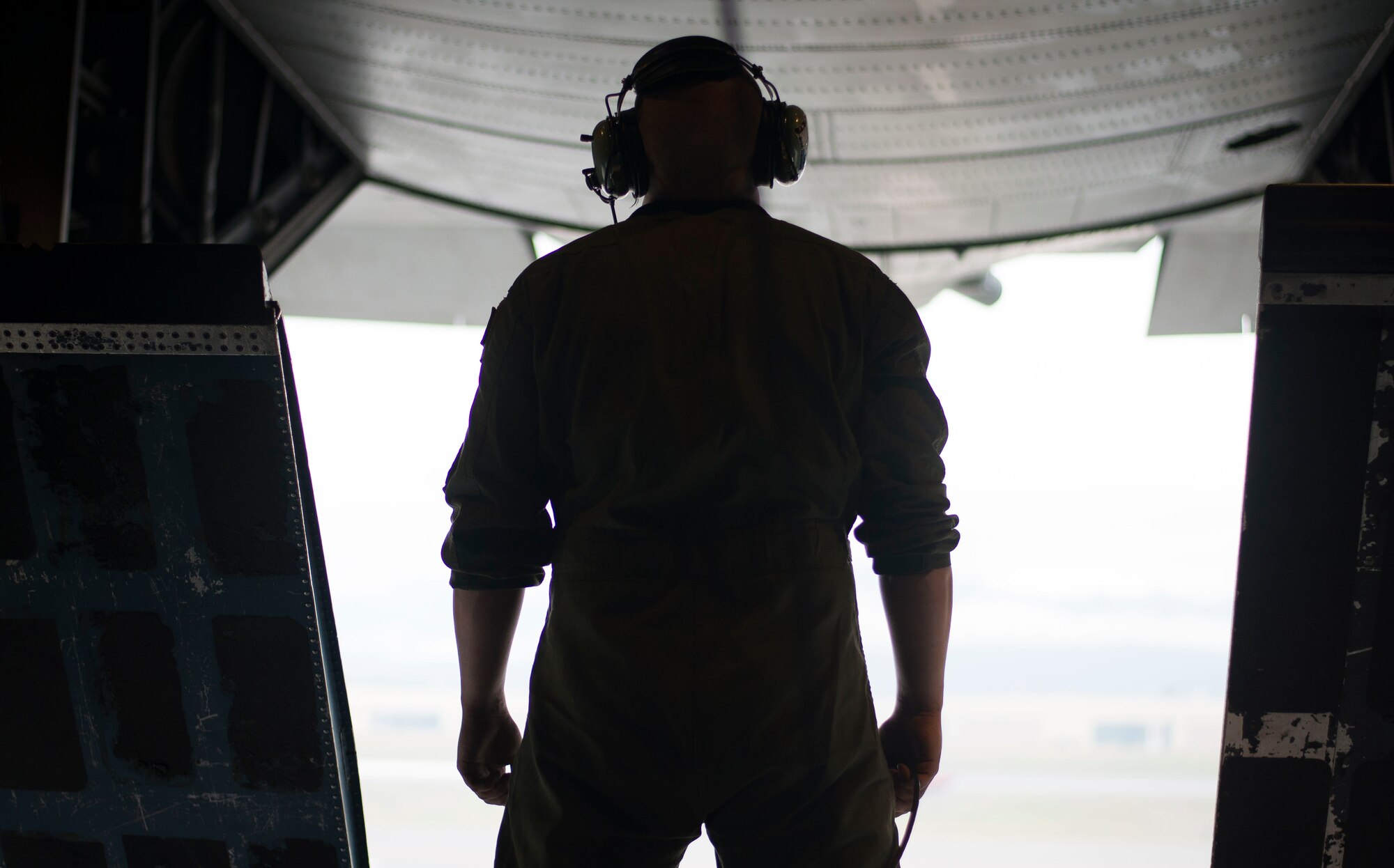Staff Sgt. Noel Jones, 36th Airlift Squadron loadmaster, looks out from the ramp of a C-130 Hercules while taxiing to the runway during a training sortie Aug. 1, 2014 at Joint Base Elmendorf-Richardson, Alaska. The 36 AS travelled to JBER for off-station training prior to Exercise Red Flag. (U.S. Air Force photo by Staff Sgt. Chad C. Strohmeyer/Released)