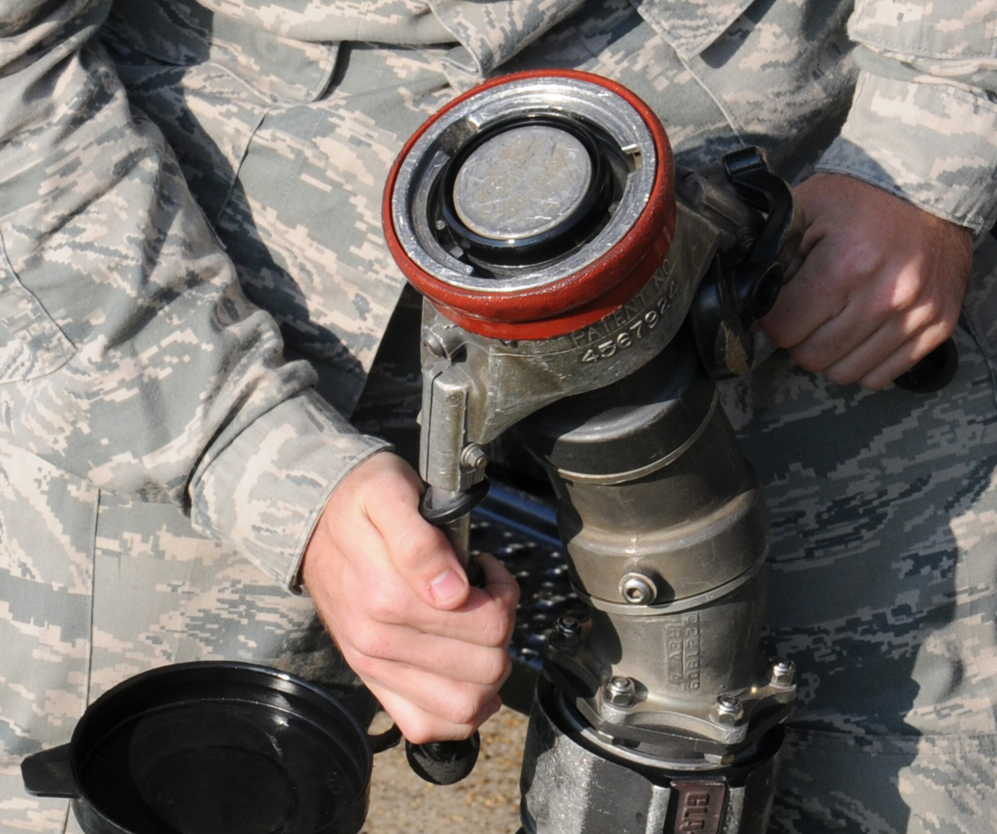 U.S. Air Force Airman 1st Class Adam Geffre, 100th Logistics Readiness Squadron Fuels distribution operator from Phoenix, Ariz., prepares to deploy a single point two and a half inch fueling hose for pressurization and inspection of wear and tear July 29, 2014, on RAF Mildenhall, England. Fuel distribution operators work with crew chiefs and aircrew to issue fuel to aircraft. (U.S. Air Force photo/Gina Randall/Released)