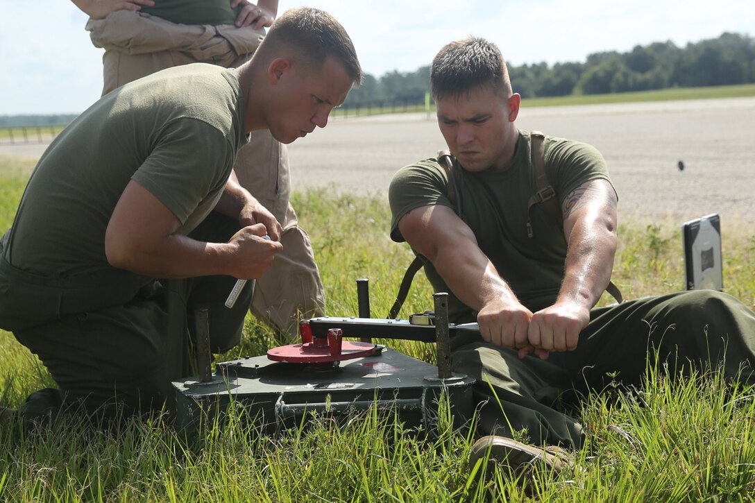 Cpl. Hunter White, left, and Sgt. Robert Basham tighten the primary catch system for the RQ-7B Shadow unmanned aerial vehicle during training at Avon Park Air Force Range, Fla., July 29, 2014. Unmanned Aerial Vehicle Squadron 2 arrived at Avon Park July 28, taking their UAVs to the field to test their aircrafts' abilities in an expeditionary environment. White and Basham are both UAV avionics technicians with the squadron.


