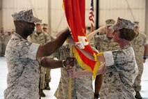 Lieutenant Colonel Priscilla Failmezger passes the flag to Lt. Col. Brent Lilly during a change of command ceremony, July 12. The passing of the flag represents the passing of responsibility of Marine wing Support Squadron 471 from the previous to the present commanding officer.