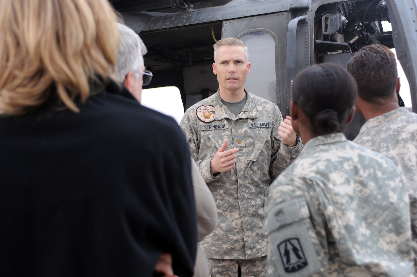 Army Maj. Jonathan Steinbach briefs passengers who will be joining him on a trip over the Kuwaiti desert, Nov. 8, 2011.