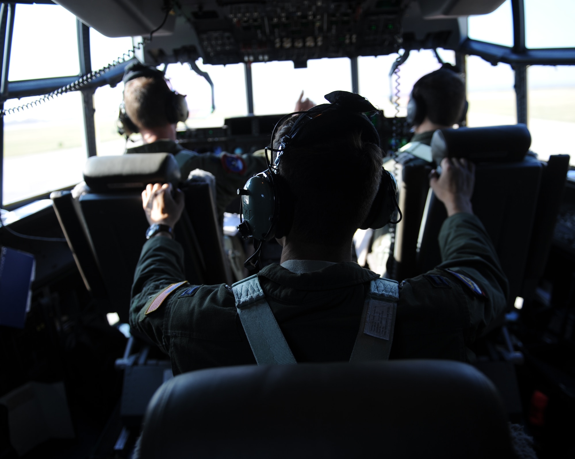 Air Force pilots prepare for takeoff in a C-130J Super Hercules July 23, 2014, at Dyess Air Force Base, Texas. Two 317th Airlift Group C-130Js successfully employed air-to-air tactics against an F-16 Fighting Falcon during a training exercise en route to Naval Air Station Joint Reserve Base Fort Worth, Texas. (U.S. Air Force photo by Airman 1st Class Kedesha Pennant)