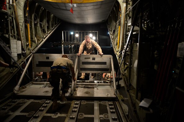 Airmen from the 774th Expeditionary Airlifit Squadron push equipment into a C-130J Super Hercules before an airdrop at Bagram Airfield, Afghanistan Aug. 1, 2014. The squadron completed an airdrop for the Afghan National Army using the new Wireless Gate Release System. (U.S. Air Force photo by Staff Sgt. Evelyn Chavez)