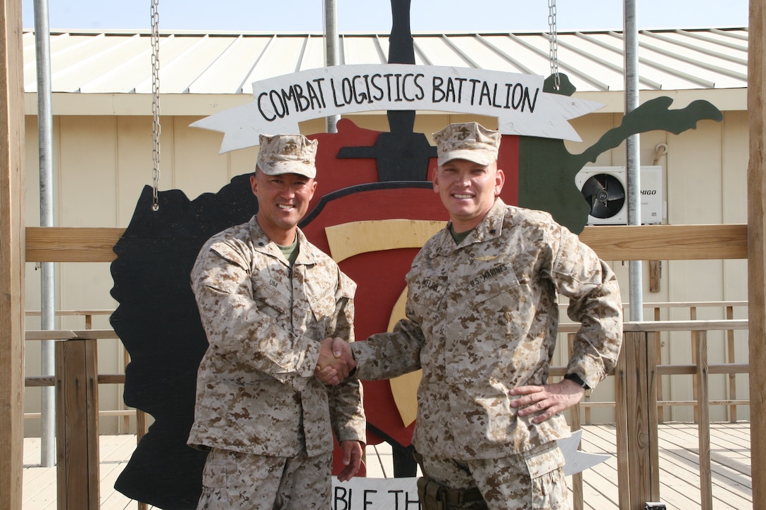 Lt. Col. Joon H. Um, left, commanding officer, Combat Logistics Battalion 1, shakes hands with Lt. Col. Sid R. Welch, commanding officer, CLB-7, after a transfer of authority ceremony held aboard Camp Leatherneck, Helmand province, Afghanistan, Aug. 1, 2014. Combat Logistics Battalion 1 replaced CLB-7 as the last unit to aid Regional Command (Southwest) with tactical-level logistical support and will close out another chapter in Marine Corps history as the last unit to serve as the logistics combat element for RC(SW).
