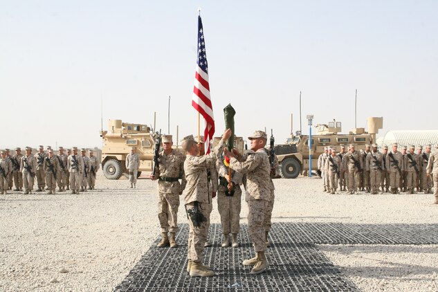 Lt. Col. Joon H. Um, right, commanding officer, Combat Logistics Battalion 1, and Sgt. Maj. Mark W. Upp, sergeant major, CLB-1, uncase the unit's battle colors during a transfer of authority ceremony held aboard Camp Leatherneck, Helmand province, Afghanistan, Aug. 1, 2014. Combat Logistics Battalion 1 replaced CLB-7 as the last unit to aid Regional Command (Southwest) with tactical-level logistical support and will close out another chapter in Marine Corps history as the last unit to serve as the logistics combat element for RC(SW).