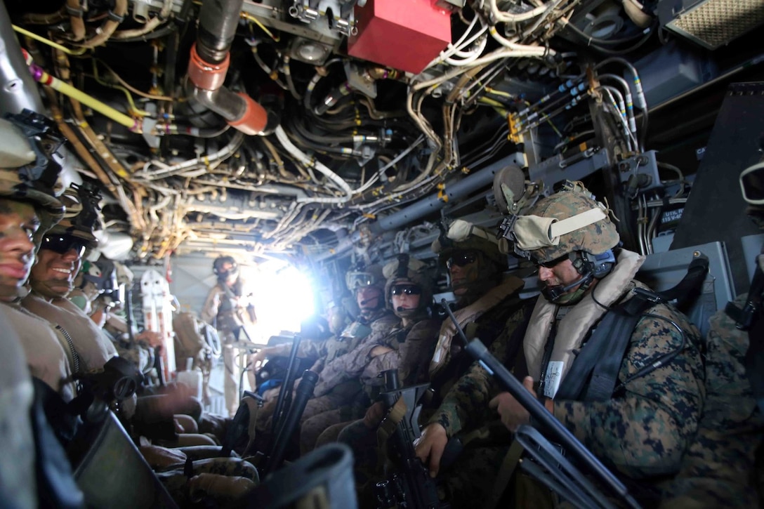 Marines and sailors with the 11th Marine Expeditionary Unit ride in an MV-22B Osprey during a long-range raid at Marine Corps Training Area Bellows, Hawaii,as part of their WESTPAC 14-2 deployment Aug. 1, 2014. The 11th MEU and Makin Island Amphibious Ready Group are deploying as a sea-based, expeditionary crisis response force capable of conducting amphibious missions across the full range of military operations. (U.S. Marine Corps photo by Cpl. Demetrius Morgan/ RELEASED)