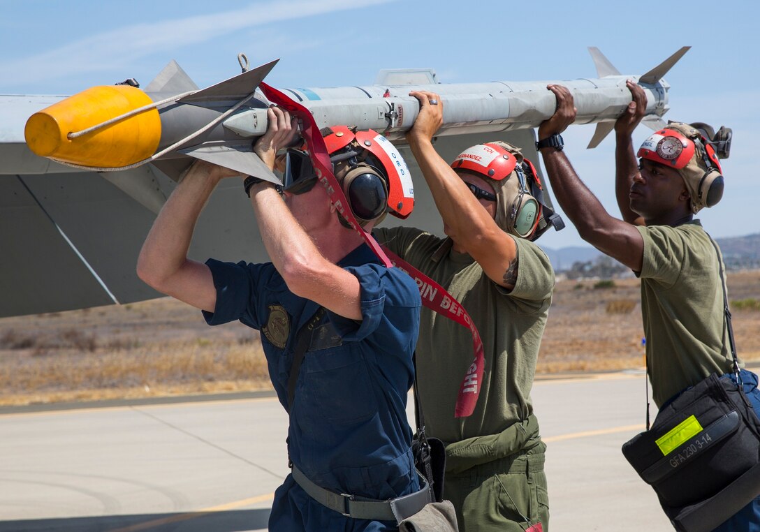 Aviation ordnance Marines with Marine All-Weather Fighter Attack Squadron (VMFA(AW)) 225 “Vikings” load a LAU-10 rocket on an F/A-18 Hornet during high-explosive ordnance loading training at the combat aircraft loading area aboard Marine Corps Air Station Miramar, Calif., July 29. The ordnance Marines also loaded the aircraft with MK-82 low-drag bombs during the training