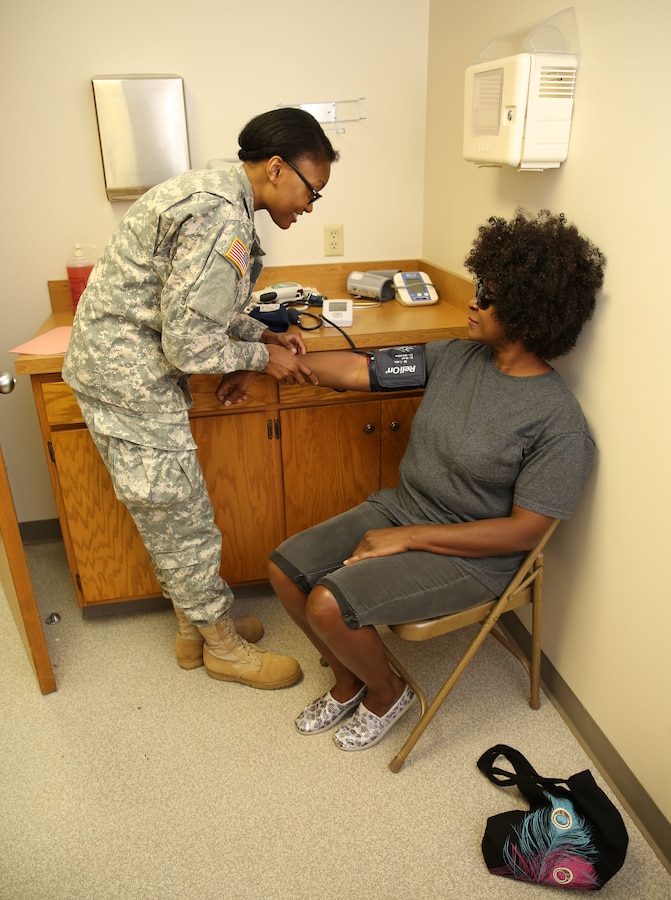 Army Sgt. Comfort Adeboje, 68X mental health specialist with 7203rd Medical Support Unit out of Hobart, Indiana and native of Chicago, Illinois checks patient Nina Phillips’ blood pressure in a routine medical screening during Innovative Readiness Training Arkansas Care, July 30, 2014. IRT Arkansas Care served the residents of a seven county area known as the Arkansas Delta region. The joint-service Reserve units provided a variety of general medical, optometry and dental services while simultaneously gaining the training they need for their military occupational specialty.