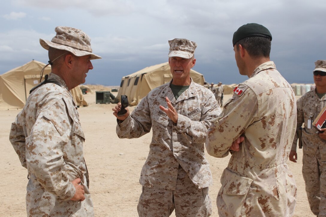 Brig. Gen. Carl E. Mundy III, commanding general of 1st Marine Expeditionary Brigade, discusses operations to be conducted in the following weeks with Col. Dani Fortin, commander of adjacent Canadian Forces, 5 Canadian Mechanized Brigade Group, during Large Scale Exercise 2014 aboard Marine Corps Air Ground Combat Center Twentynine Palms, Calif., Aug. 3, 2014. LSE-14 is a bilateral training exercise being conducted by 1st MEB to build U.S. and Canadian forces’ joint capabilities through live, simulated, and constructive military training activities from Aug. 8-14. (U.S. Marine Corps photo by Lance Cpl. Angel Serna/Released)