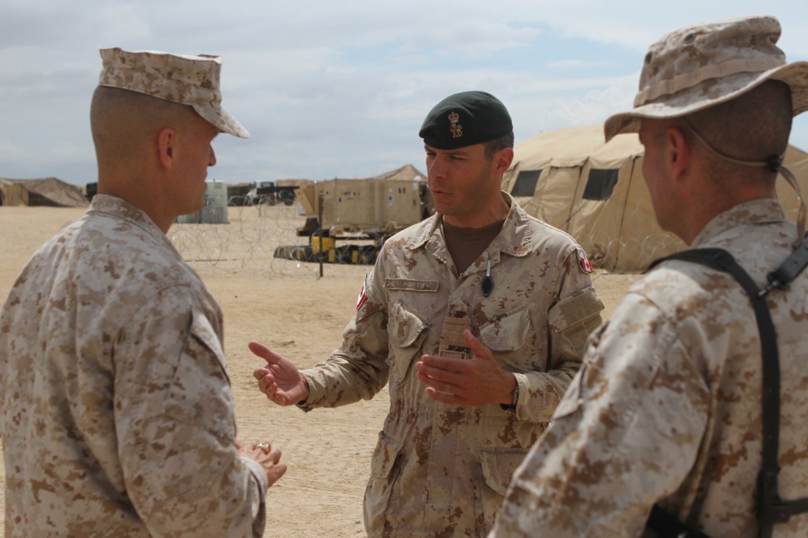 Col. Dani Fortin, commander of adjacent Canadian Forces, 5 Canadian Mechanized Brigade Group, discusses operations to be conducted in the following weeks with Brig. Gen. Carl E. Mundy III, commanding general of 1st Marine Expeditionary Brigade, during Large Scale Exercise 2014 aboard Marine Corps Air Ground Combat Center Twentynine Palms, Calif., Aug. 3, 2014. LSE-14 is a bilateral training exercise being conducted by 1st MEB to build U.S. and Canadian forces’ joint capabilities through live, simulated, and constructive military training activities from Aug. 8-14. (U.S. Marine Corps photo by Lance Cpl. Angel Serna/Released)