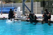 Special Amphibious Reconnaissance Corpsman enter the water pool side, during proficiency dive training aboard Camp Pendleton, Calif., July 22. The SARCs were supported by Navy Divers from 1st Reconstruction consolidated dive locker.
