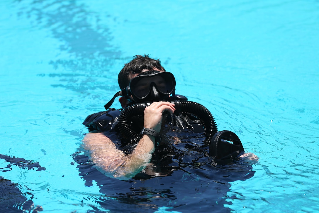 A Special Amphibious Reconnaissance Corpsman surfaces after a 10 minute dive during proficiency dive training aboard Camp Pendleton, Calif., July 22. The SARCs were supported by Navy Divers from 1st Reconstruction consolidated dive locker.