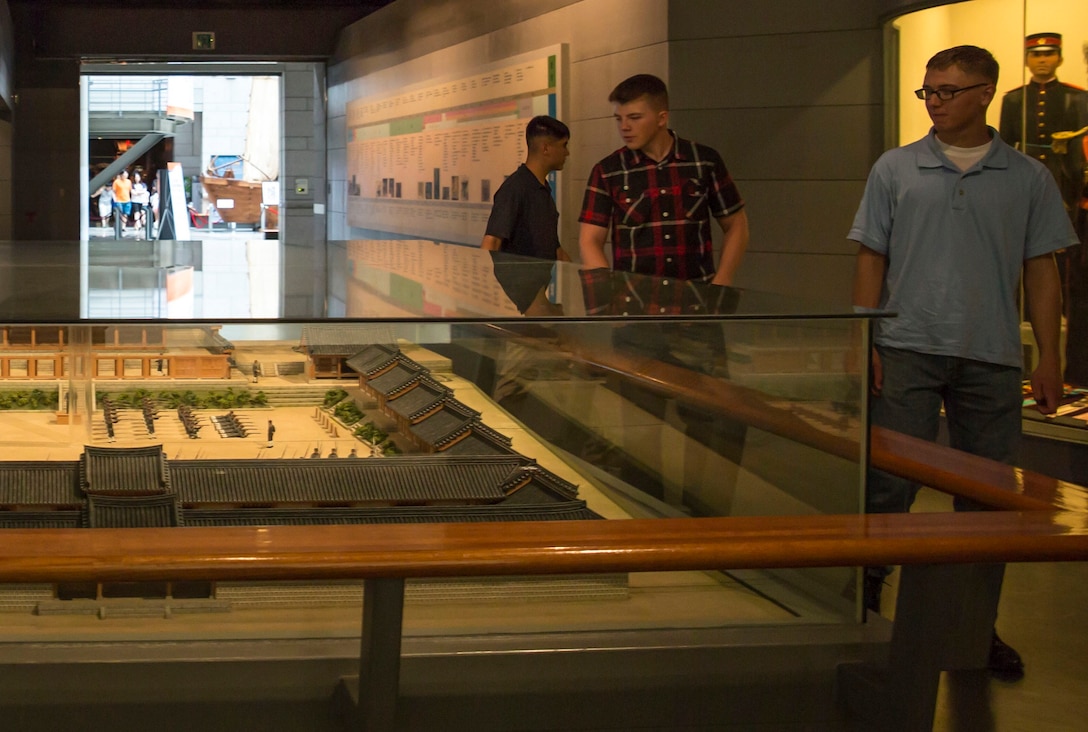 U.S. Marine Lance Cpls. Arvid B. Johnson, right, Daniel D. McKinney, second from right, observe a display replicating military training of the Taehan Empire July 17 during a visit to the War Memorial of Korea in Seoul, Republic of Korea. Visiting the museum gave the U.S. Marines an opportunity to learn more about the history of their ROK Marine counterparts before beginning Korean Marine Exchange Program 14-12. U.S. Marines will execute bilateral training to familiarize themselves with the South Korean peninsula and enhance interoperability with ROK Marines. Johnson is a Salt Lake City, Utah, native, and McKinney is a Houston, Texas, native. Both are ground radio repairmen with Combat Assault Battalion, 3rd Marine Division, III Marine Expeditionary Force. (U.S. Marine Corps photo by Lance Cpl. Diamond N. Peden/Released)