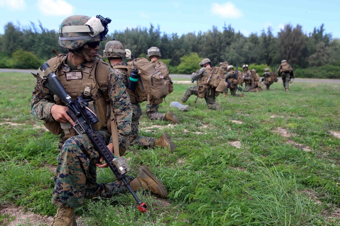 Marines with Golf Company, Battalion Landing Team, 2nd Battalion, 1st Marines, 11th Marine Expeditionary Unit, establish landing zone security during a long-range raid at Marine Corps Training Area Bellows, Hawaii, as part of their WESTPAC 14-2 deployment Aug. 1, 2014. The 11th MEU and Makin Island Amphibious Ready Group are deploying as a sea-based, expeditionary crisis response force capable of conducting amphibious missions across the full range of military operations.