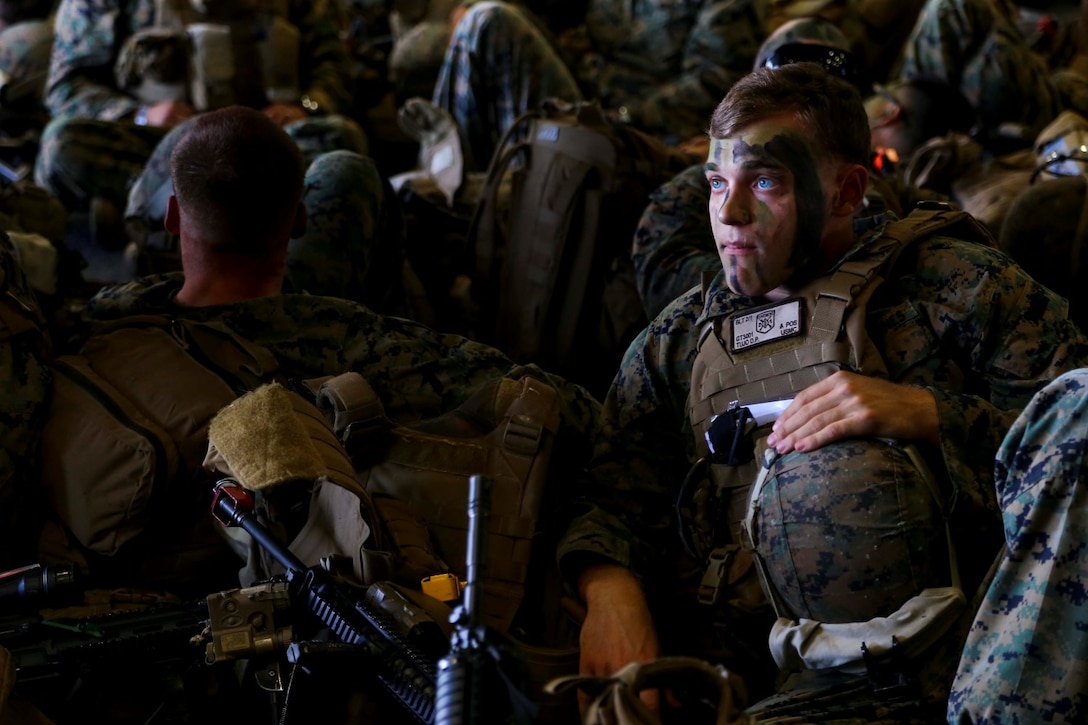 Cpl. Daniel P. Tujo a rifleman with Golf Company, Battalion Landing Team 2nd Battalion, 1st Marines (BLT 2/1), 11th Marine Expeditionary Unit, and Brookfield, Illinois native waits in the hangar bay of   the USS Makin Island  before leaving for training at  Marine Corps Training Area  Bellows, Hawaii  Aug 1..  The 11th MEU and Makin Island Amphibious Ready Group are deployed as a sea-based, expeditionary crisis response force capable of conducting amphibious missions across the full range of military operations. (U.S. Marine Corps photo by Lance Cpl. Laura Y. Raga/Released)