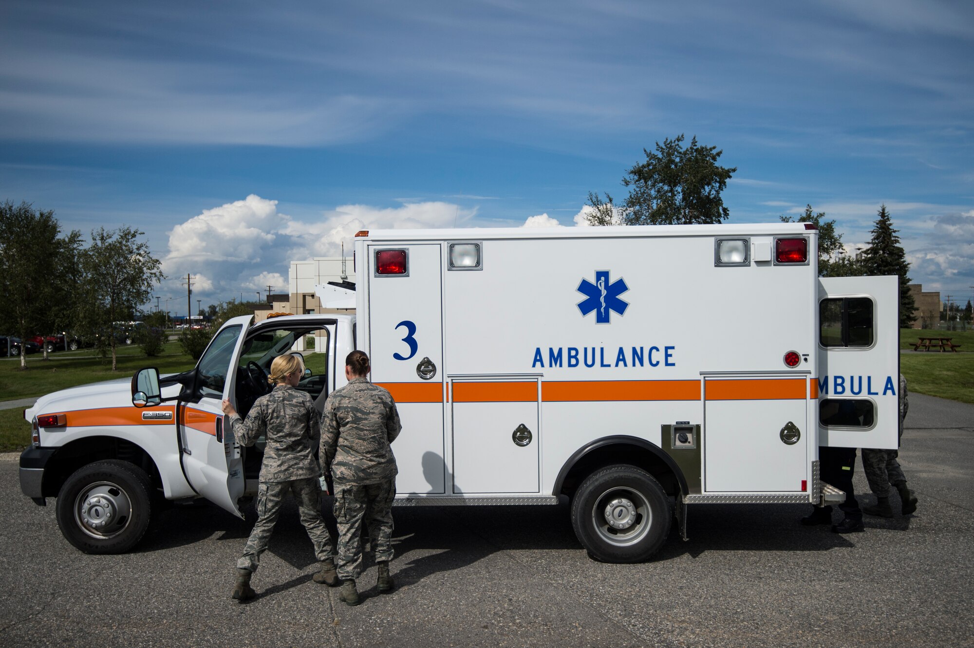 Tech Sgt. Mandy Mueller, 354th Medical Operations Squadron paramedic, trains Airman 1st Class Kaylan Padgett, 354th MDOS medical technician, on the different procedures in an ambulance at Eielson Air Force Base, Alaska, Aug. 4, 2014. As an ambulance crew, members are responsible for the transport of victims to emergency medical facilities in the event of a crisis and Eielson AFB receives about 200 calls a year. (U.S. Air Force photo by Staff Sgt. Stephany Richards/ Released)