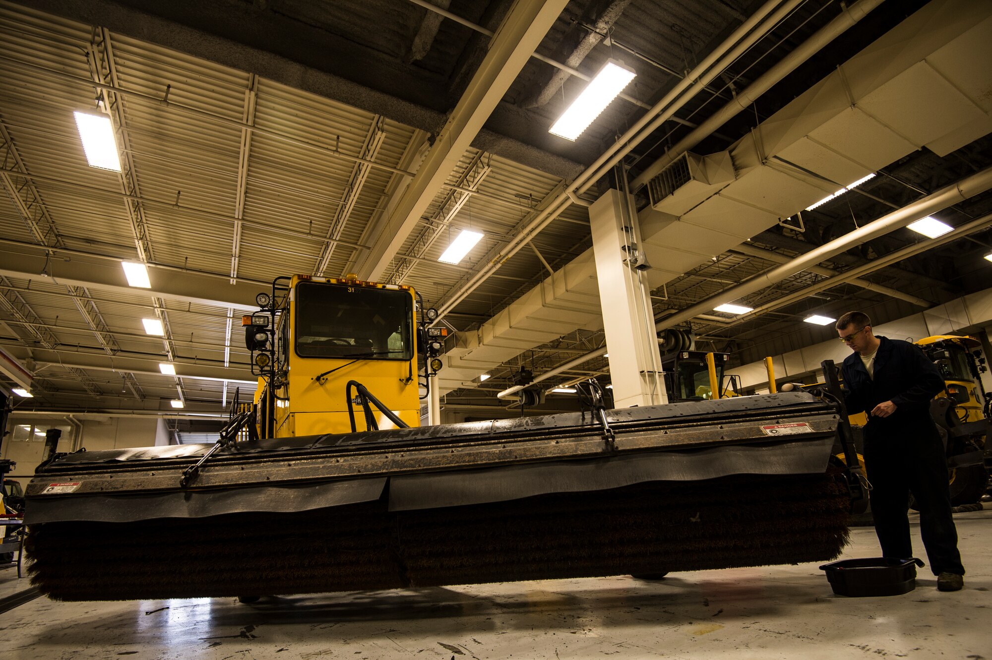 Senior Airman Anthony Tavares, 354th Logistics Readiness Squadron vehicle maintainer, repairs a leaky hydraulic hose and cylinder on a flightline snow broom at Eielson Air Force Base, Alaska, Aug. 4, 2014. The 354th LRS is responsible for managing and maintaining the government vehicle fleet which incorporates an immense and diverse snow fleet in addition to all the cargo, passenger and household goods movements for Eielson AFB. (U.S. Air Force photo by Staff Sgt. Stephany Richards/ Released)