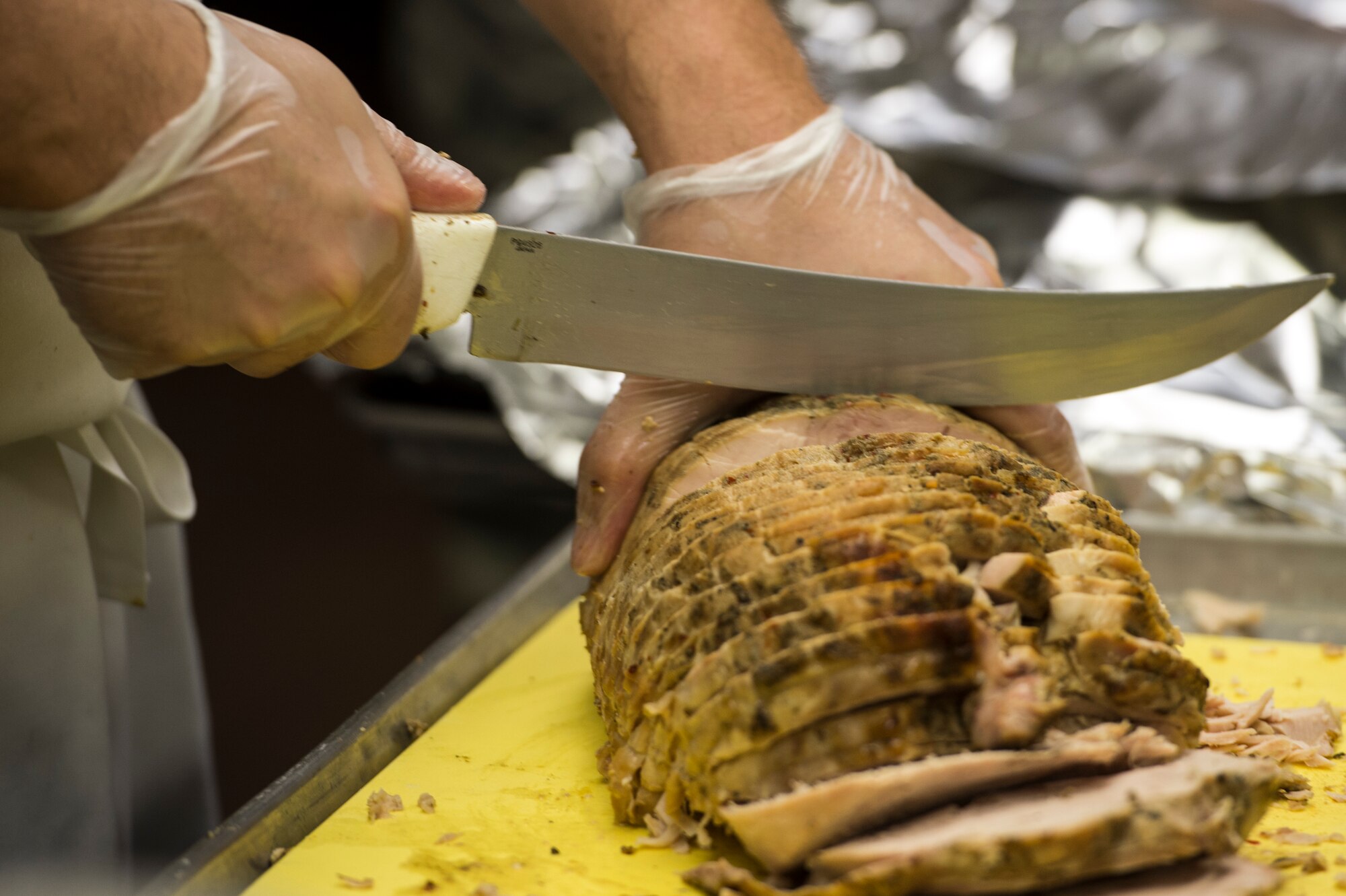 Staff Sgt. Michael Lockeart, 354th Force Support Squadron shift leader, prepares turkey for a lunch service at Eielson Air Force Base, Alaska, Aug. 4, 2014. The dining facility feeds about 400 Airmen a day. The 354th FSS has more than 450 assigned military and contract personnel that provide manpower, personnel services and programs to enhance morale, quality of life, personnel readiness, family support and education and training for the Eielson AFB community. (U.S. Air Force photo by Staff Sgt. Stephany Richards/ Released)