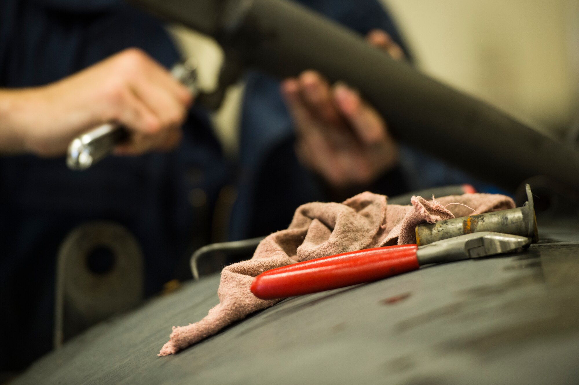 Senior Airman Anthony Tavares, 354th Logistics Readiness Squadron vehicle maintainer, repairs a leaky hydraulic hose and cylinder on a flightline snow broom at Eielson Air Force Base, Alaska, Aug. 4, 2014.  The 354th LRS is responsible for managing and maintaining the government vehicle fleet which incorporates an immense and diverse snow fleet in addition to all the cargo, passenger and household goods movements for Eielson AFB. (U.S. Air Force photo by Staff Sgt. Stephany Richards/ Released)