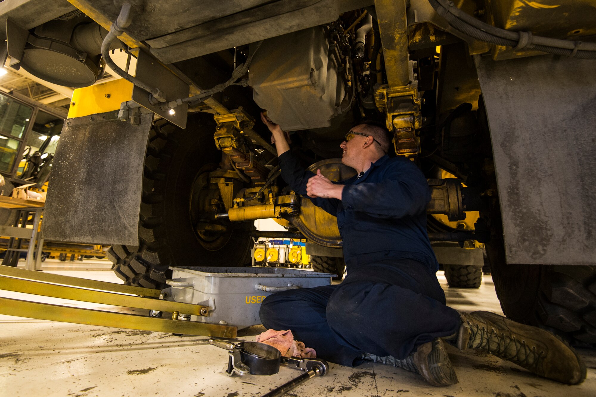 Senior Airman Anthony Tavares, 354th Logistics Readiness Squadron vehicle maintainer, changes the oil on a flightline snow broom at Eielson Air Force Base, Alaska, Aug. 4, 2014. The 354th LRS is responsible for managing and maintaining the government vehicle fleet which incorporates an immense and diverse snow fleet in addition to all the cargo, passenger and household goods movements for Eielson AFB. (U.S. Air Force photo by Staff Sgt. Stephany Richards/ Released)
