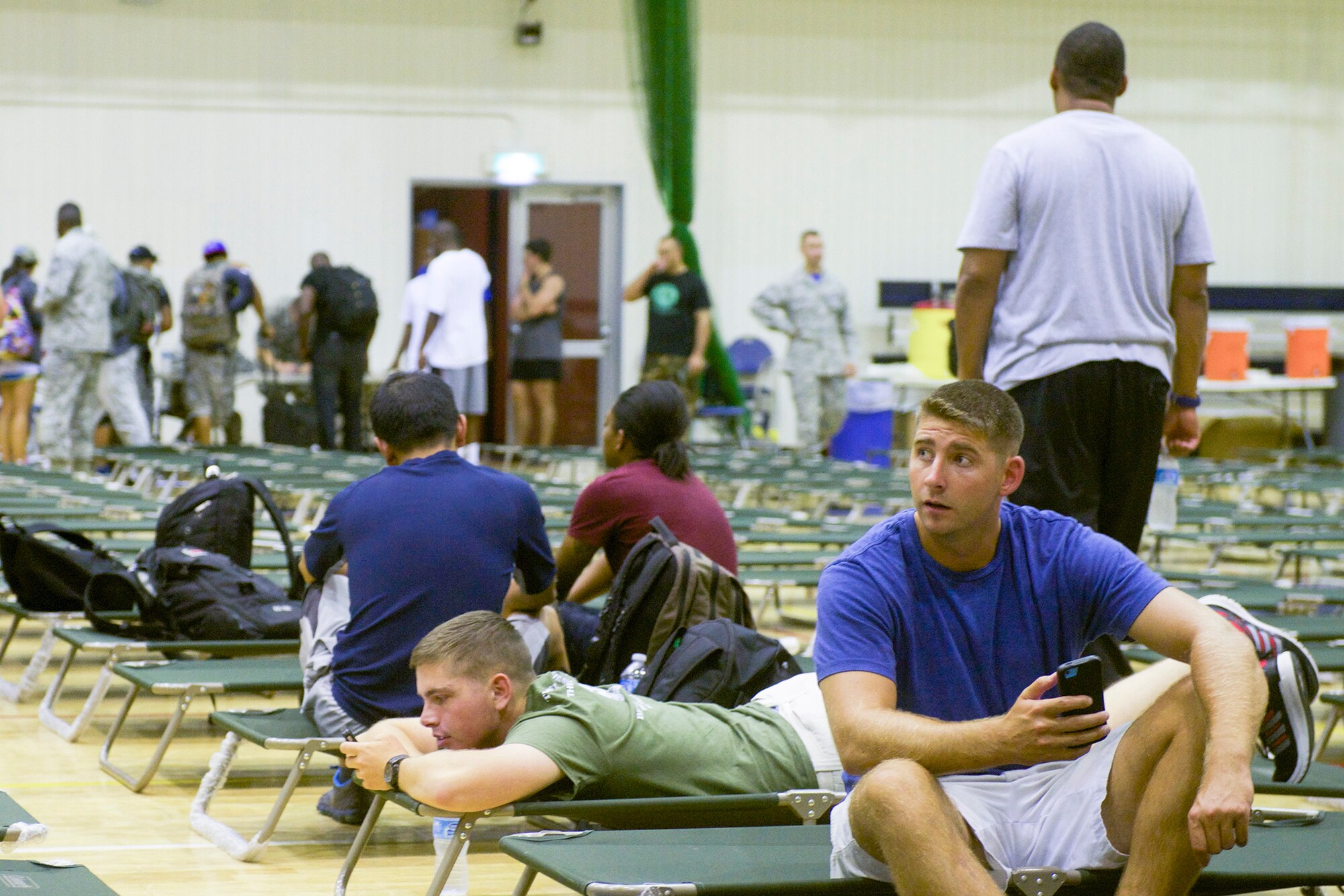 Passengers whose rotator flights were delayed due to inclement weather in Okinawa, Japan spend the night in the Samurai Fitness Center at Yokota Air Base, Japan, Aug. 1, 2014. . As a transient location in the Western Pacific, Yokota provides shelter for displaced passengers when flight conditions become untenable. (U.S. Air Force photo by Airman 1st Class David C. Danford/Released)