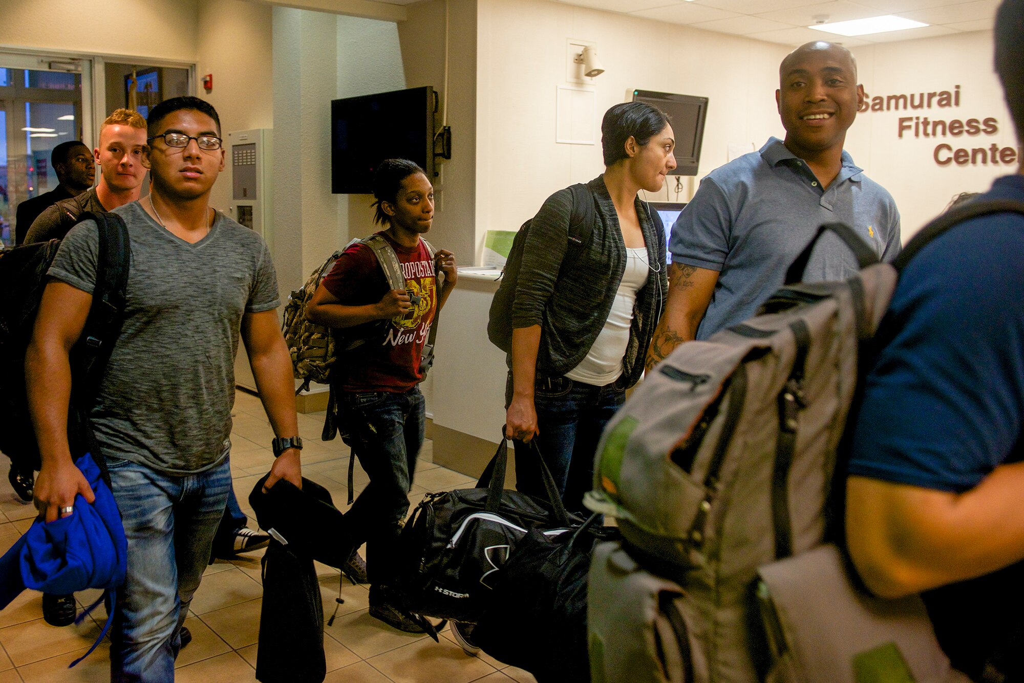 Passengers whose flight was delayed by a monsoonal trough passing through Okinawa, Japan spend the night in the Samurai Fitness Center at Yokota Air Base, Japan on Aug. 1, 2014. As a transient location in the Western Pacific, Yokota provides shelter for displaced passengers when flight conditions become untenable. (U.S. Air Force photo by Airman 1st Class David C. Danford/Released)